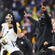 Pittsburgh Steelers head coach Mike Tomlin, masked, reacts to overtime game-winning kick by kicker Chris Boswell after an NFL football game against the Baltimore Ravens, Sunday, Jan. 9, 2022, in Baltimore.